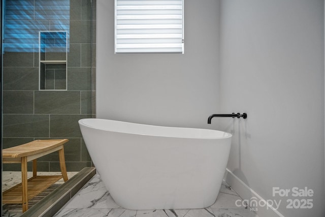 bathroom with marble finish floor, a tile shower, and a soaking tub