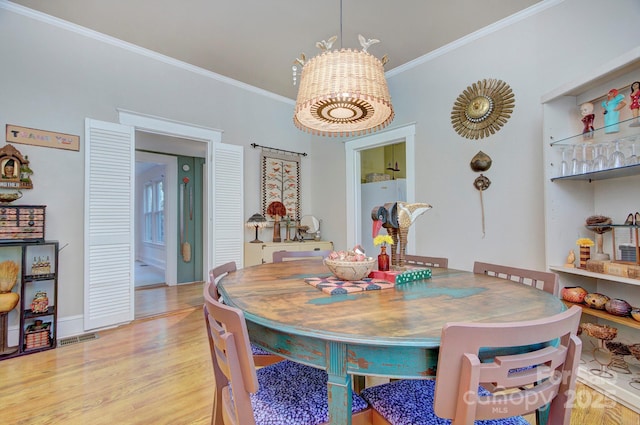 1000 E 35th St, Charlotte, NC 28205 - dining room featuring ornamental molding, wood finished floors, and visible vents
