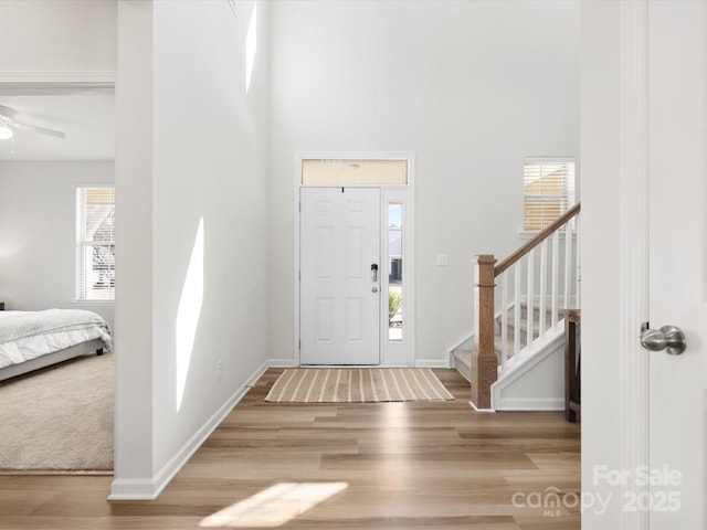 5532 Muckross Ln, Fort Mill, SC 29707 - entryway featuring baseboards, a high ceiling, wood finished floors, and stairs