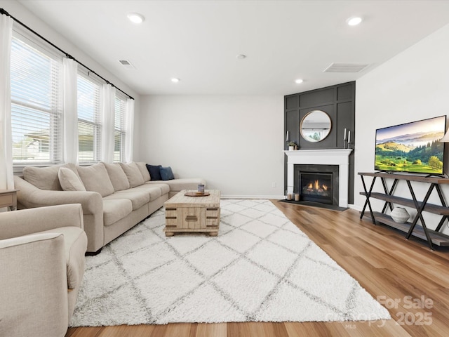 5532 Muckross Ln, Fort Mill, SC 29707 - living area with wood finished floors, a large fireplace, visible vents, and recessed lighting