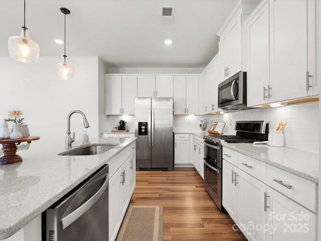 5532 Muckross Ln, Fort Mill, SC 29707 - kitchen with light wood-type flooring, backsplash, visible vents, stainless steel appliances, and a sink