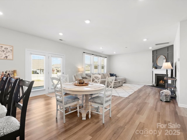 5532 Muckross Ln, Fort Mill, SC 29707 - dining area featuring a fireplace with flush hearth, light wood finished floors, baseboards, and recessed lighting
