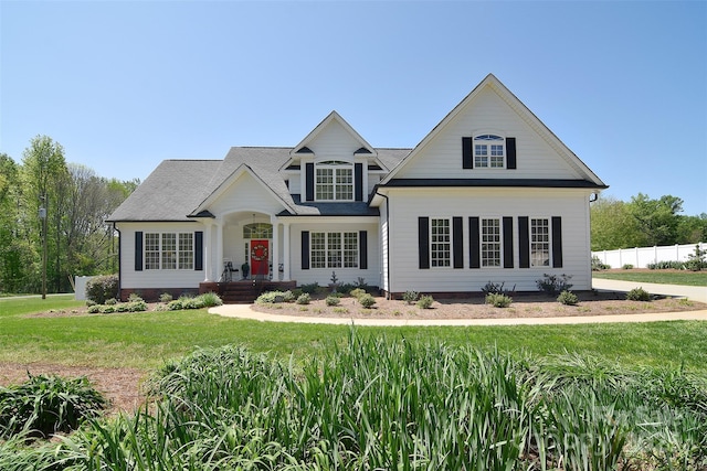 view of front of house with a front lawn, fence, and crawl space