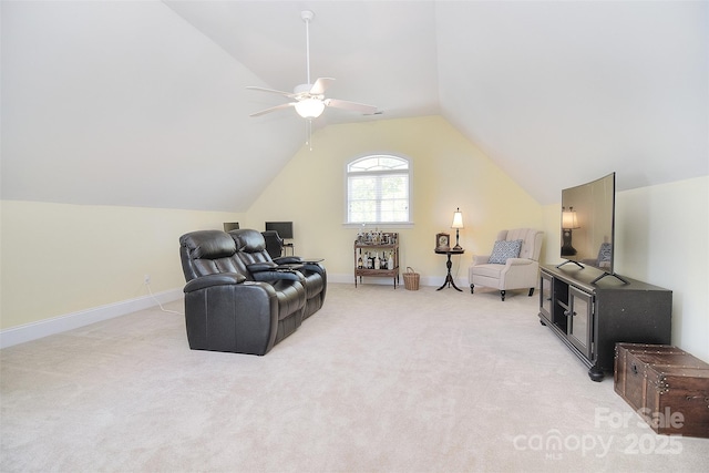 living area featuring baseboards, light colored carpet, a ceiling fan, and lofted ceiling