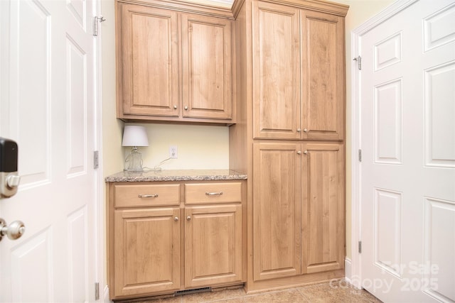 kitchen with visible vents and light stone counters