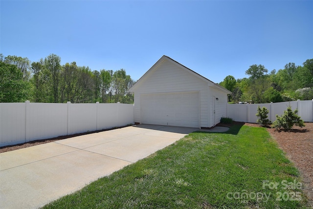 detached garage featuring fence