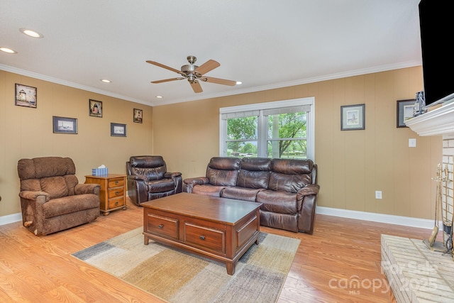 living room with a ceiling fan, recessed lighting, ornamental molding, and light wood finished floors