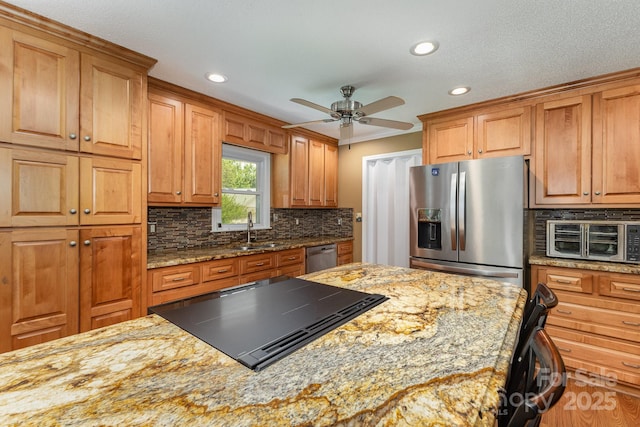 kitchen with a sink, appliances with stainless steel finishes, a toaster, and recessed lighting