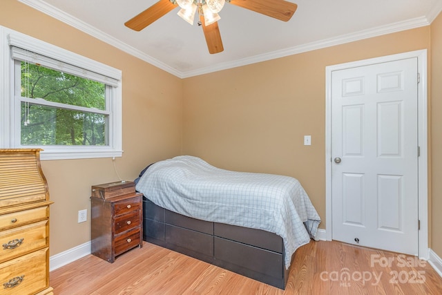 bedroom with baseboards, ornamental molding, and light wood-style flooring