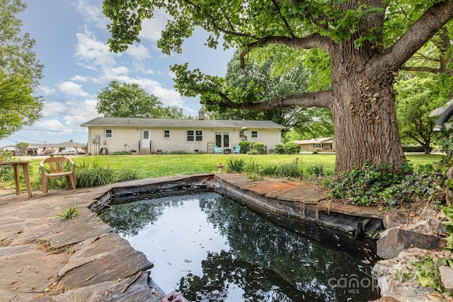 back of house featuring a yard