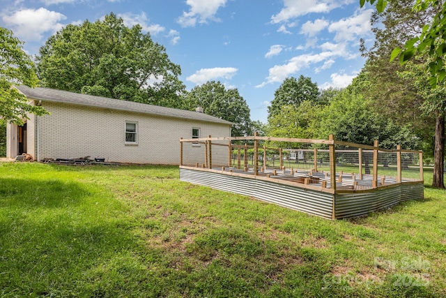 back of house featuring a yard and brick siding