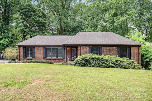 4813 Carving Tree Dr, Mint Hill, NC 28227 - ranch-style home with a shingled roof, a front lawn, and brick siding