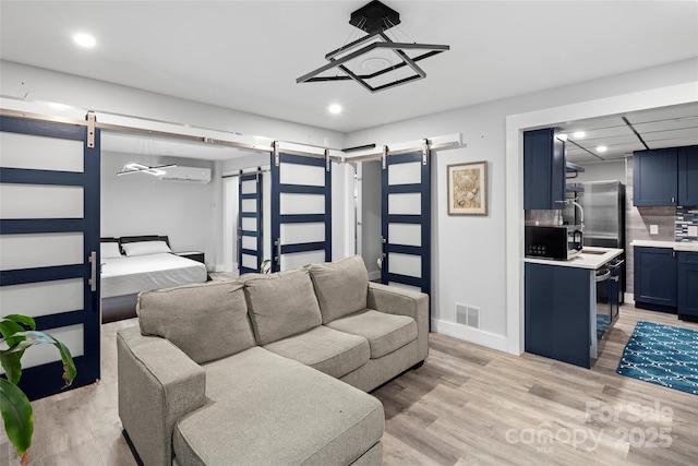 34 Turnberry Dr, Arden, NC 28704 - living room featuring visible vents, light wood-style flooring, recessed lighting, and a barn door
