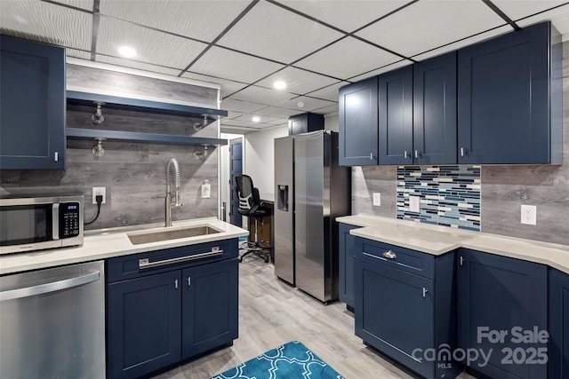 34 Turnberry Dr, Arden, NC 28704 - kitchen with blue cabinetry, open shelves, light wood-style floors, appliances with stainless steel finishes, and a sink