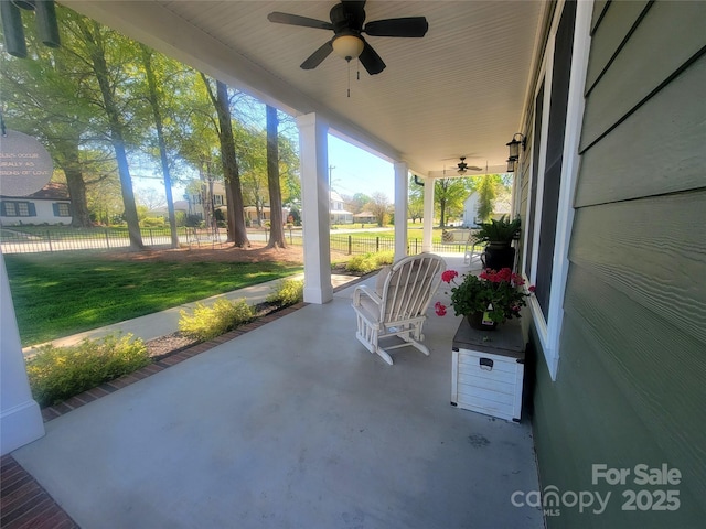 view of patio with fence, a porch, and a ceiling fan