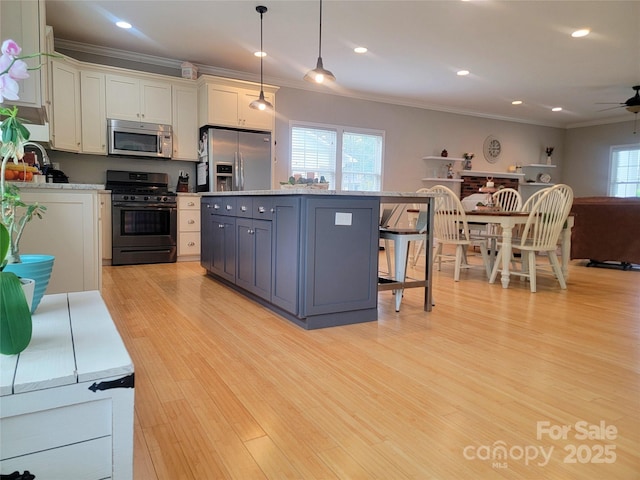 kitchen featuring white cabinetry, crown molding, light wood-style floors, ceiling fan, and stainless steel appliances