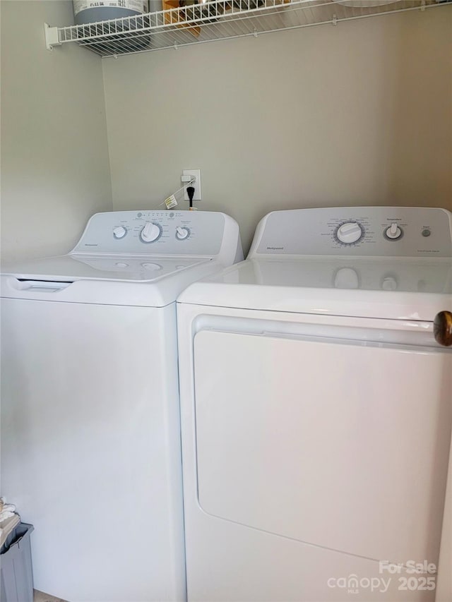 laundry area with separate washer and dryer and laundry area