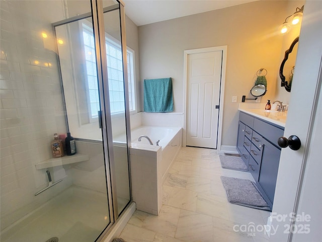 bathroom with vanity, marble finish floor, a garden tub, and a stall shower