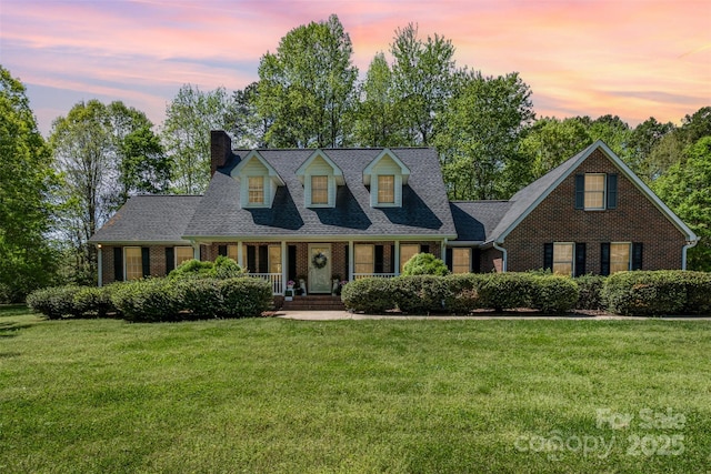 127 Fantasy Ln, Mooresville, NC 28117 - cape cod-style house with brick siding, a front yard, and a chimney