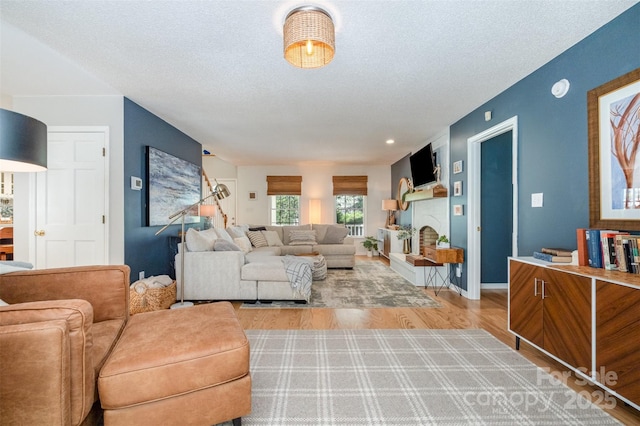 127 Fantasy Ln, Mooresville, NC 28117 - living room with a textured ceiling, wood finished floors, and baseboards