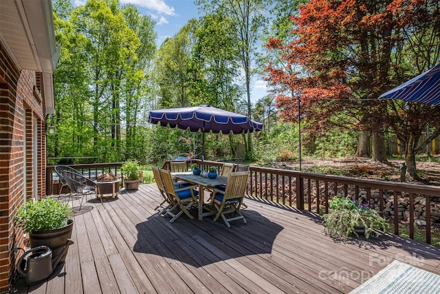 127 Fantasy Ln, Mooresville, NC 28117 - wooden deck with outdoor dining space and view of scattered trees