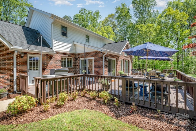 127 Fantasy Ln, Mooresville, NC 28117 - back of property with outdoor dining area, brick siding, a deck, and roof with shingles