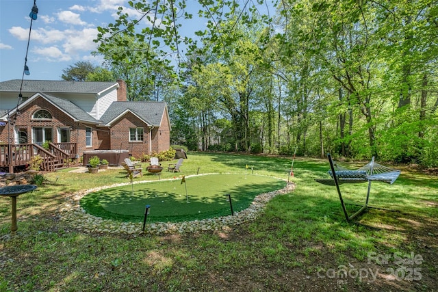 127 Fantasy Ln, Mooresville, NC 28117 - view of grassy yard with a hot tub, an area to practice putting, and a deck