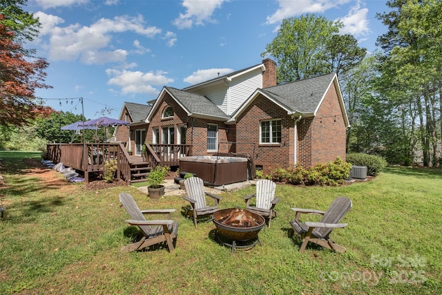 127 Fantasy Ln, Mooresville, NC 28117 - back of house featuring a hot tub, a fire pit, brick siding, a deck, and roof with shingles
