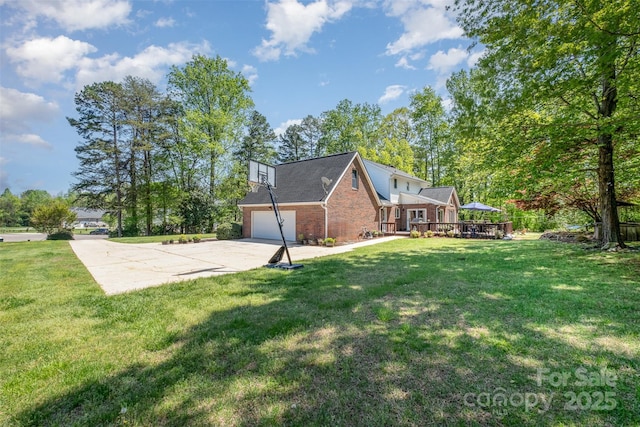 127 Fantasy Ln, Mooresville, NC 28117 - back of house featuring driveway, brick siding, a yard, a wooden deck, and a garage