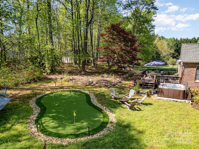 127 Fantasy Ln, Mooresville, NC 28117 - view of green lawn featuring a putting area, a hot tub, a deck, and an outdoor fire pit