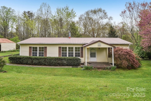 single story home with a front yard and metal roof