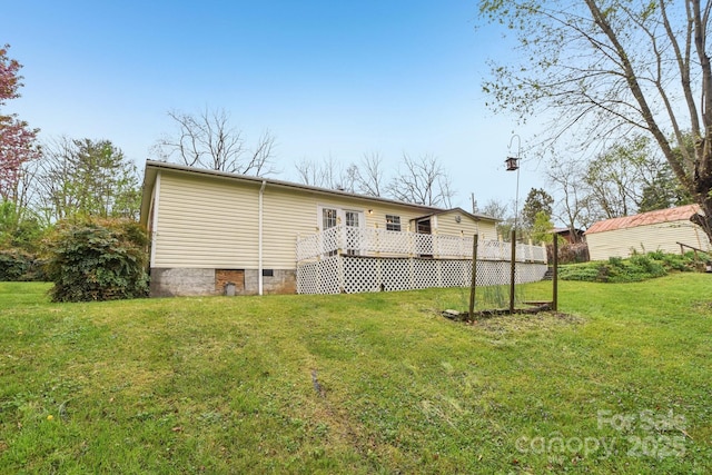 back of property featuring crawl space, a yard, and a deck