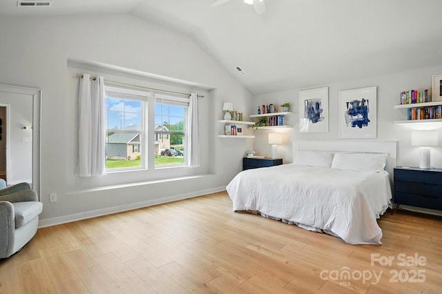 bedroom featuring visible vents, wood finished floors, a ceiling fan, and vaulted ceiling