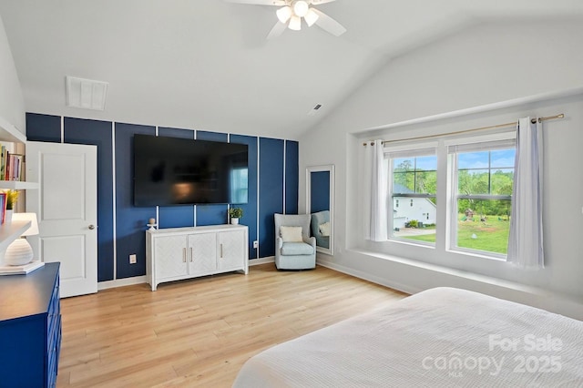 bedroom featuring light wood finished floors, baseboards, visible vents, a ceiling fan, and lofted ceiling