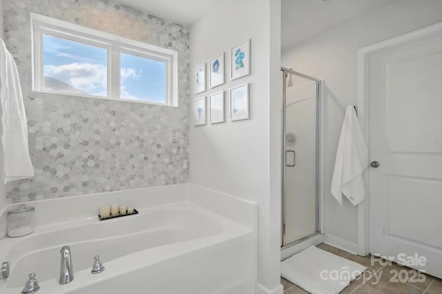 bathroom featuring tile patterned floors, a shower stall, and a bath