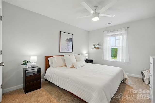 bedroom with baseboards, visible vents, light carpet, and ceiling fan