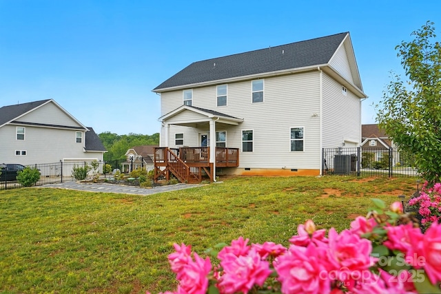 rear view of house featuring a deck, a fenced backyard, a yard, and crawl space