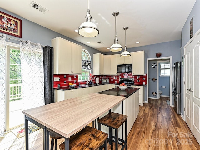 3914 Cassidy Dr, Waxhaw, NC 28173 - kitchen with black microwave, electric range, freestanding refrigerator, dark countertops, and recessed lighting