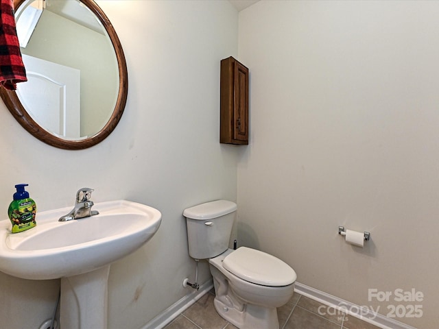 3914 Cassidy Dr, Waxhaw, NC 28173 - bathroom with tile patterned floors, toilet, baseboards, and a sink