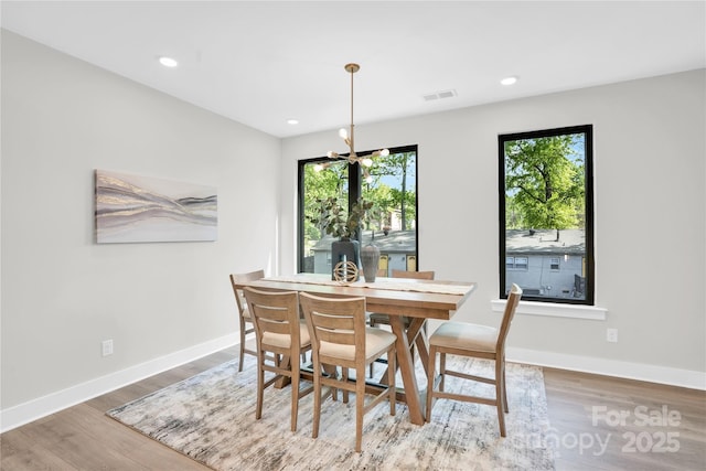 3449 Byrnes St, Charlotte, NC 28205 - dining area featuring wood finished floors, healthy amount of natural light, baseboards, recessed lighting, and a chandelier