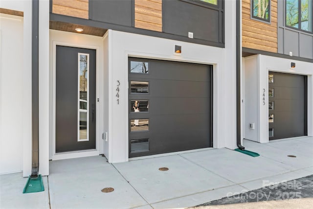3449 Byrnes St, Charlotte, NC 28205 - view of exterior entry featuring a garage and stucco siding