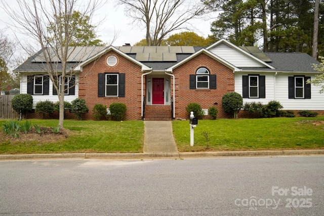 204 Foley Dr, Garner, NC 27529 - single story home featuring brick siding, solar panels, roof with shingles, and a front lawn