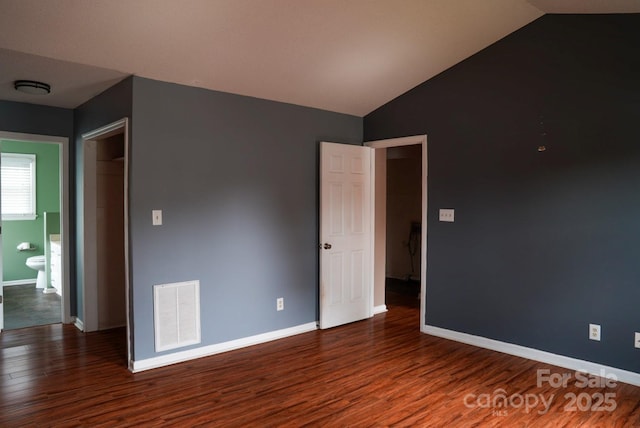204 Foley Dr, Garner, NC 27529 - unfurnished bedroom featuring lofted ceiling, wood finished floors, visible vents, and baseboards