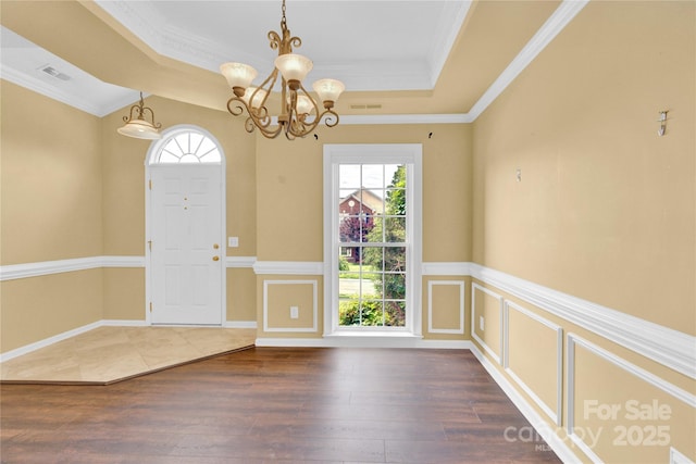 4155 Guilford Ct NW, Concord, NC 28027 - foyer entrance featuring a tray ceiling, healthy amount of natural light, a chandelier, hardwood / wood-style floors, and ornamental molding