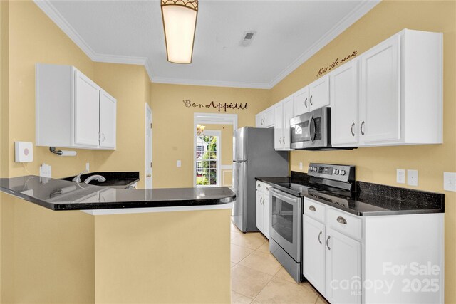 4155 Guilford Ct NW, Concord, NC 28027 - kitchen with appliances with stainless steel finishes, crown molding, white cabinetry, dark stone counters, and a peninsula