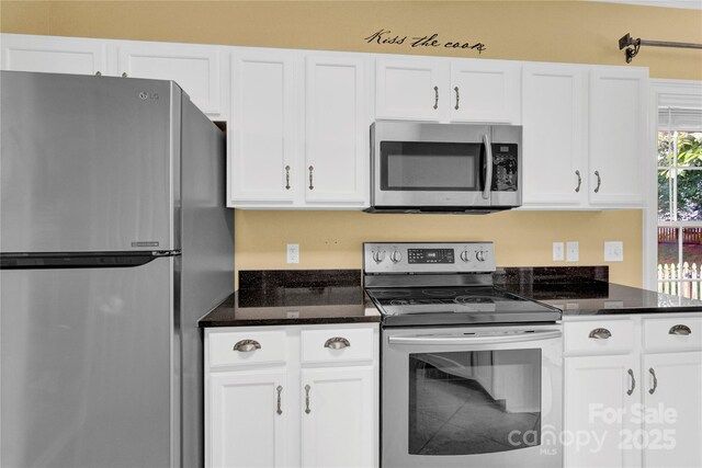 4155 Guilford Ct NW, Concord, NC 28027 - kitchen with stainless steel appliances, white cabinets, and dark stone countertops
