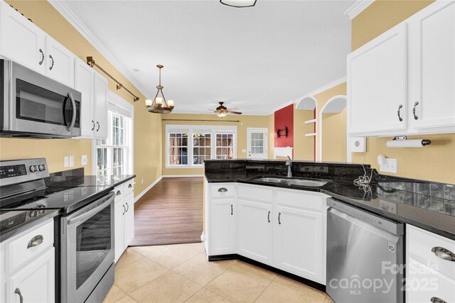 4155 Guilford Ct NW, Concord, NC 28027 - kitchen with stainless steel appliances, a sink, ornamental molding, a ceiling fan, and light tile patterned flooring
