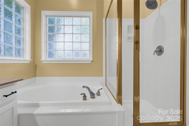 4155 Guilford Ct NW, Concord, NC 28027 - bathroom with healthy amount of natural light, a stall shower, and a bath