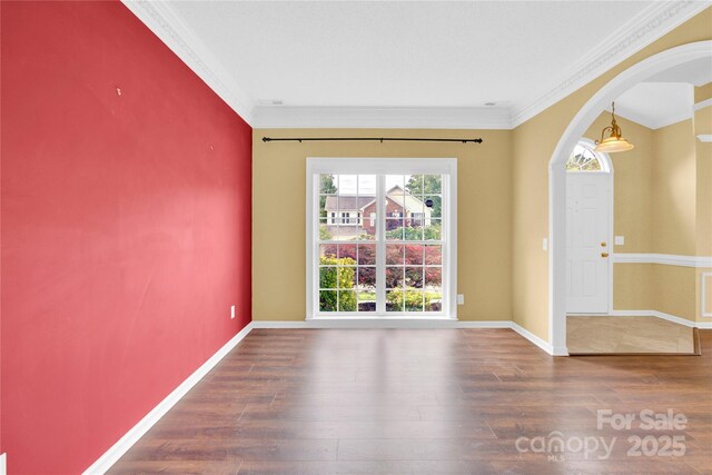 4155 Guilford Ct NW, Concord, NC 28027 - empty room with plenty of natural light, arched walkways, crown molding, wood finished floors, and baseboards