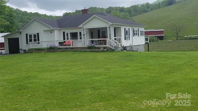 18 Misty Meadows Rd, Burnsville, NC 28714 - view of front facade featuring a chimney, a front lawn, and covered porch